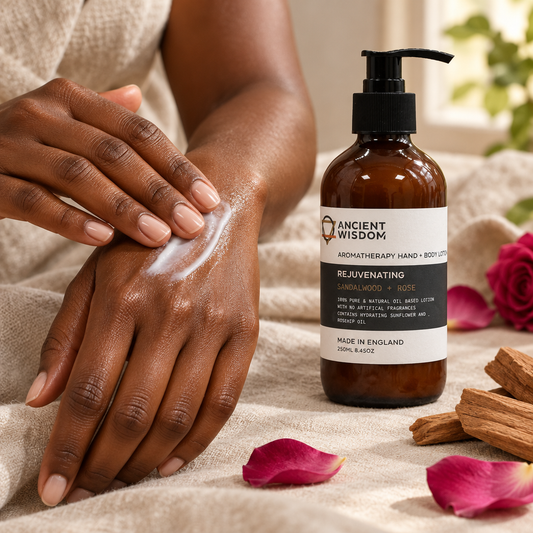 Deep-brown hands rubbing in Sandalwood and Rose lotion beside the bottle